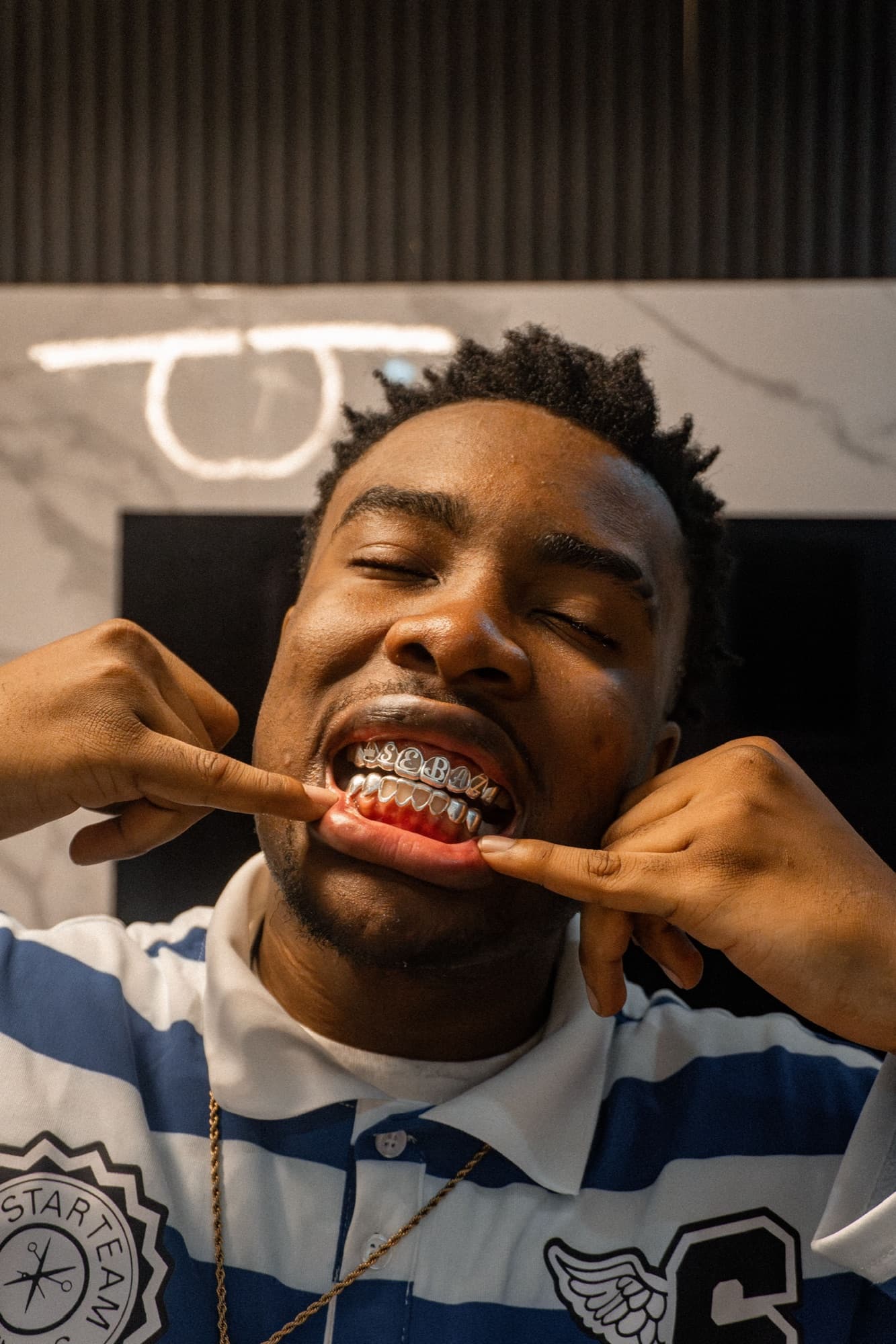 Client showing custom lettered grillz