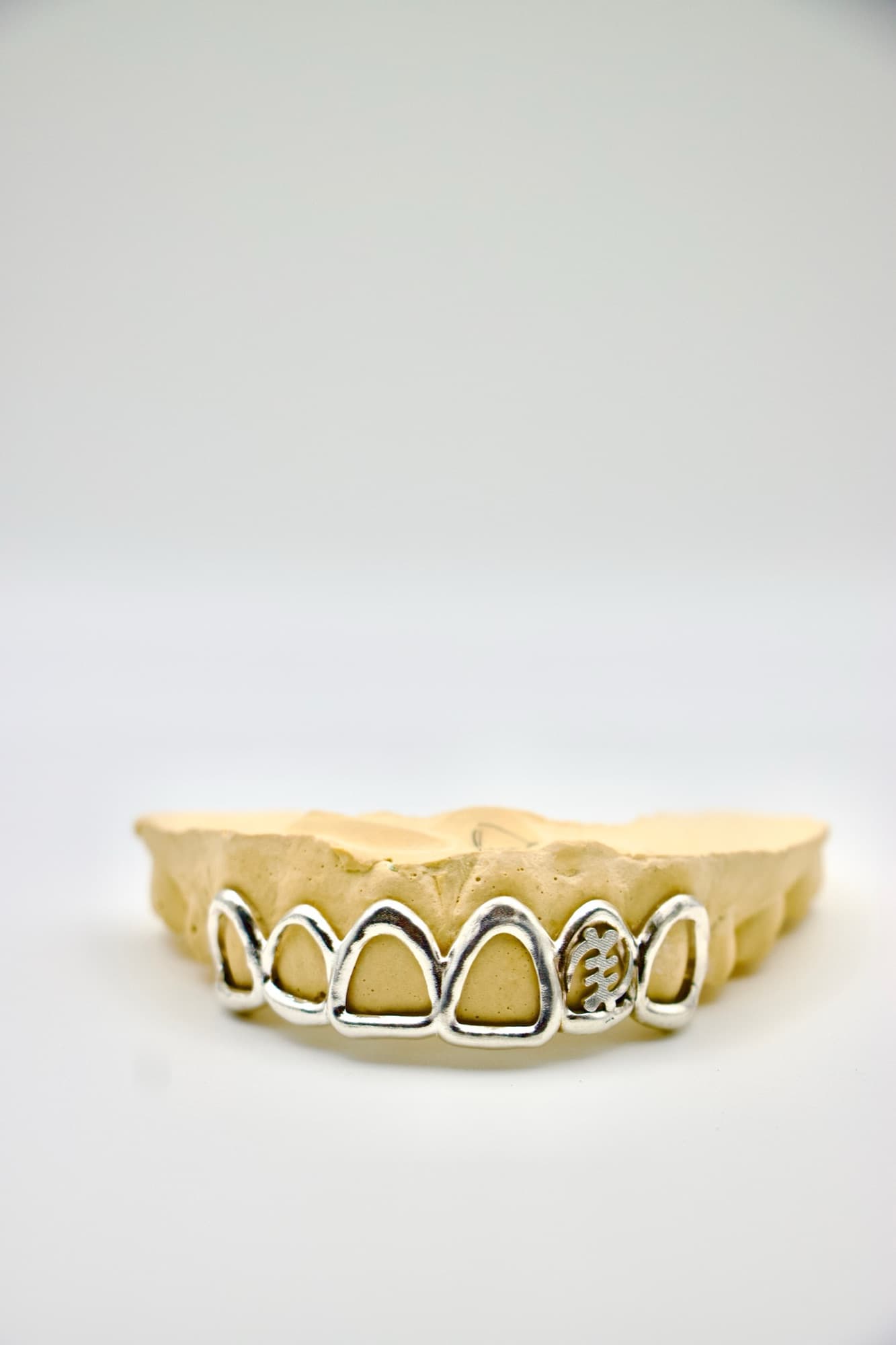 Six-tooth silver open-face set with a Gye Nyame cutout